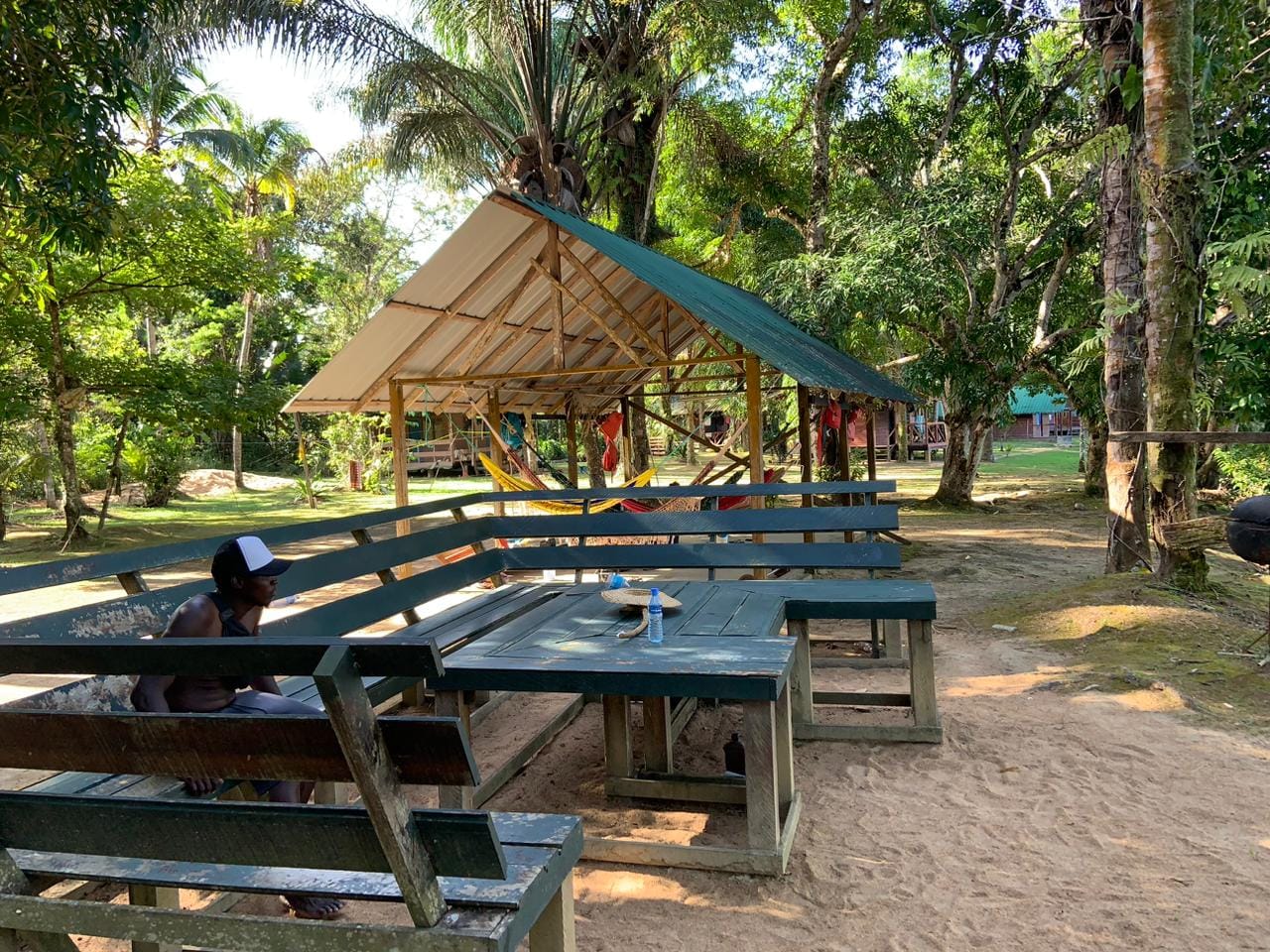 Open-air hammock and dining shelter at the riverside resort